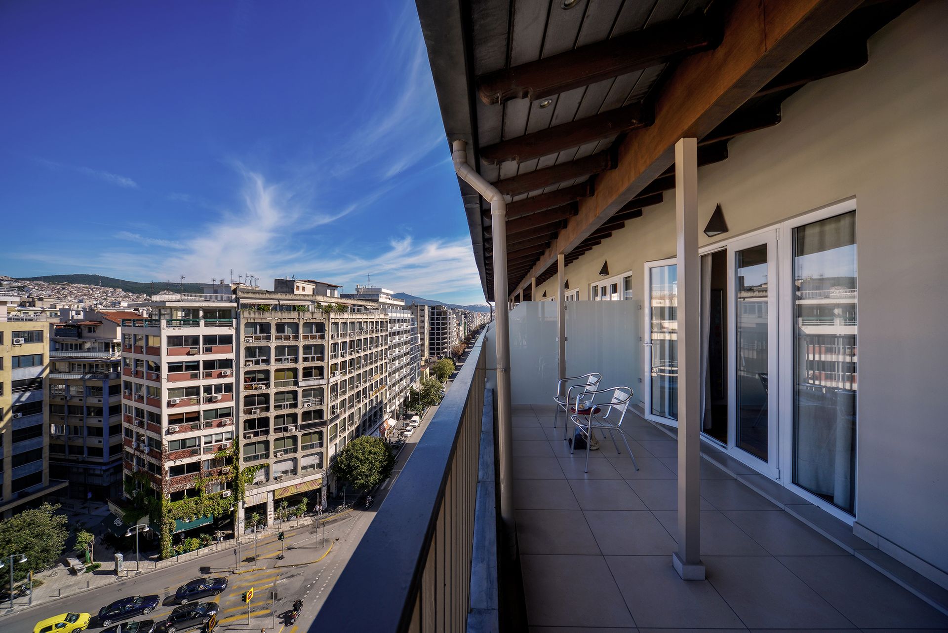 The Penthouse Suites at Astoria Hotel Thessaloniki feature private balconies equipped with comfortable seating arrangements, offering guests a serene space to relax while enjoying panoramic views of the city and harbor.