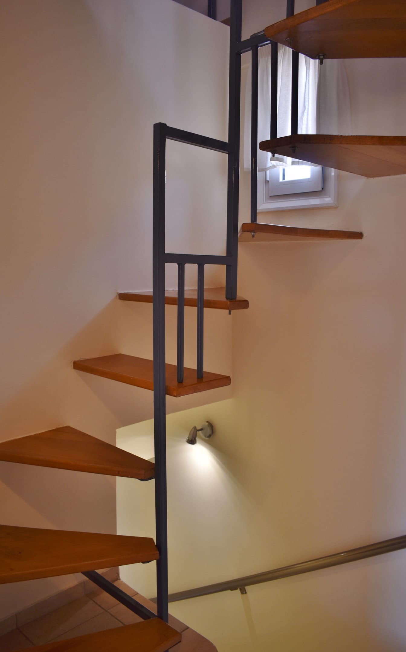 Stairs from the second level to the attic with the balcony overlooking the sea