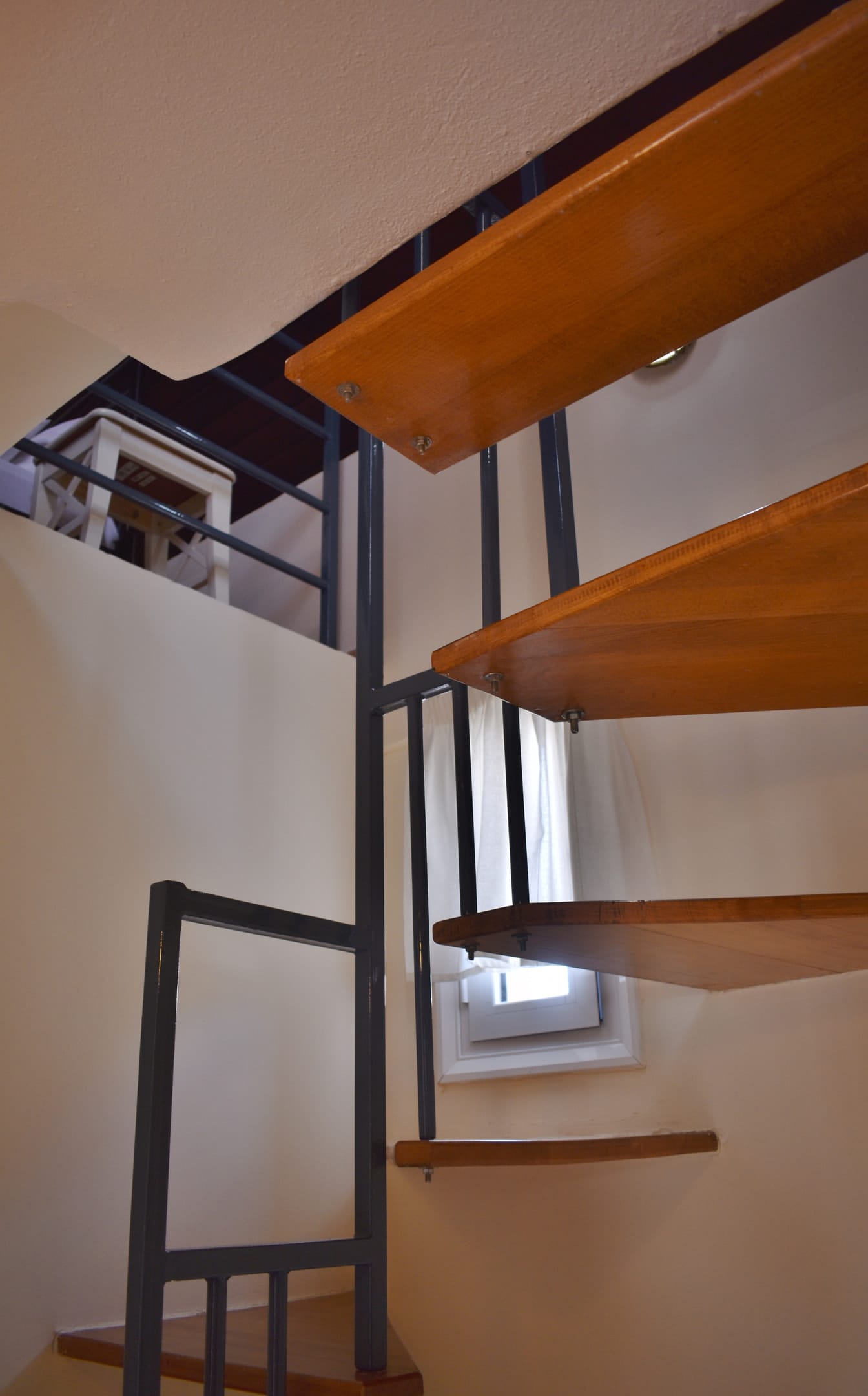 Stairs from the second level to the attic with the balcony overlooking the sea