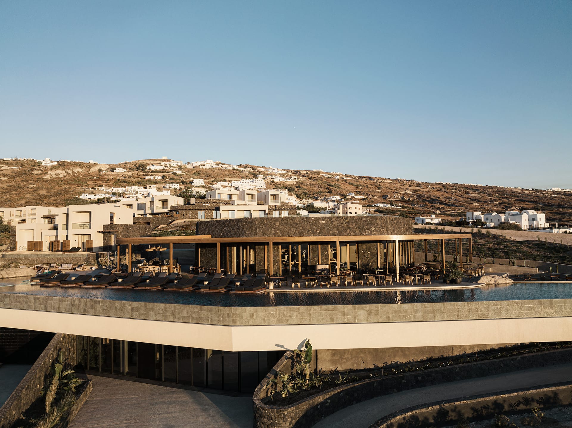 The architecture and design serve as a profound tribute to the island's natural beauty, drawing inspiration from the majestic volcano. They deftly harness timeless forces—water, light, and air—fashioning a contemporary marvel immersed in historical a